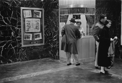 Man Purchasing A Movie Ticket From A Woman In A Ticket Booth As A Couple Stands To The Side History - Item # VAREVCHCDLCGAEC201