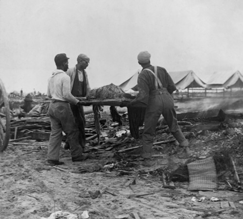 African American Men Carrying A Body On Stretcher To A Fire To Be Cremated. Initial Burials At Sea Caused Bodies To Be Washed Back To The Texas Coast. Sept. 12 History - Item # VAREVCHISL046EC249