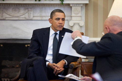 President Obama Studies A Document Held By National Intelligence Director James Clapper During The Presidential Daily Briefing In The Oval Office. Feb. 3 2011. History - Item # VAREVCHISL027EC103