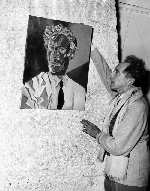 Jean Cocteau Adjusts His Self-Portrait At An Exhibition In Nice History - Item # VAREVCPBDJECOCS001