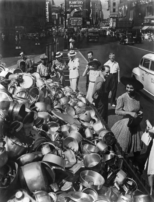 Collection Point In New York City For Aluminum During World War 2. Ca. 1942-45. African American And White Pedestrians Smile At The Pots Collected For The War Effort. History - Item # VAREVCHISL036EC869