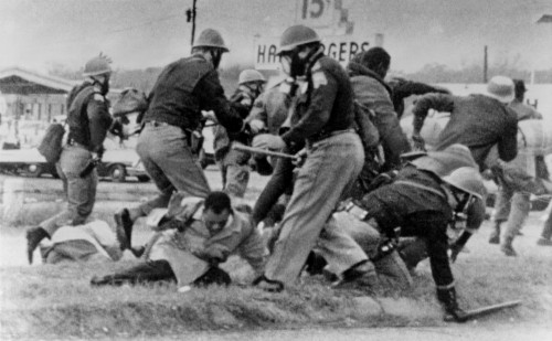 Sncc Leader John Lewis Cringes As An Alabama State Trooper Swings His Club At Lewis' Head. Lewis Was Hospitalized For A Head Injury. March 7 History - Item # VAREVCHISL033EC621