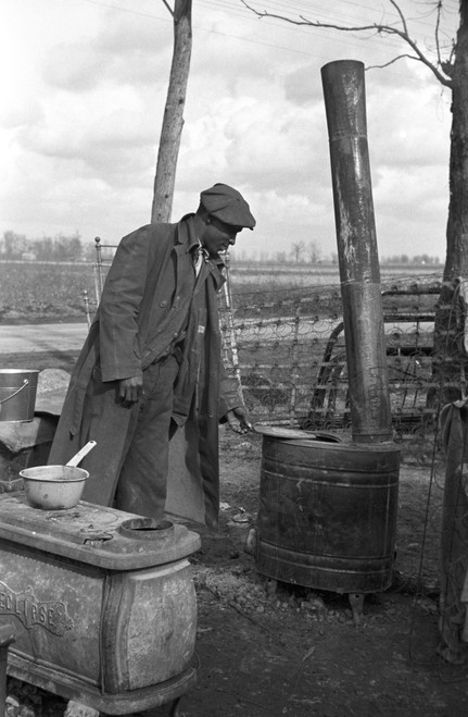 Sharecropper, 1939. /Nevicted Sharecropper Preparing A Meal With A Woodburning Stove In A Roadside Camp Along Highway 60, New Madrid County, Missouri. Photograph By Arthur Rothstein In January 1939. Poster Print by Granger Collection - Item # VARGRC0