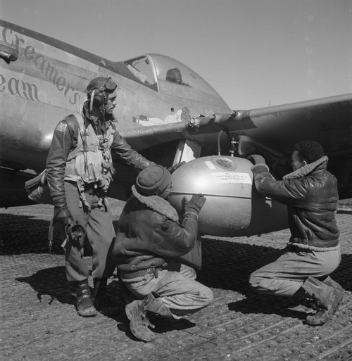 Tuskegee airman Edward C. Gleed, Lawrence, KS, Class 42-K, with two unidentified crewmen adjusting an external seventy-five gallon drop taken on the wing of a P-5/D, "Creamer's Dream." Ramitelli, Italy, March 1945. Poster Print - Item # VARBLL0587631