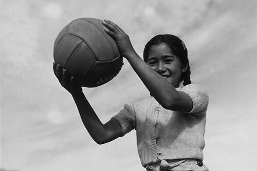 Girl and volley ball.  Ansel Easton Adams was an American photographer, best known for his black-and-white photographs of the American West.  During part of his career, he was hired by the US Government to record life in the West. Poster Print by Ans