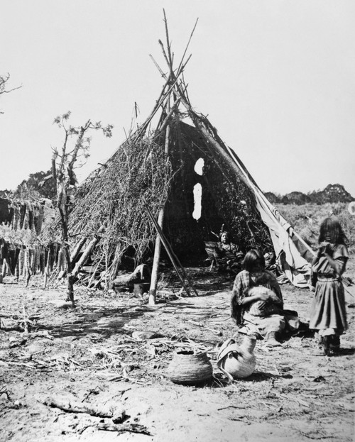 Ute Dwelling, C1873. /Nthe Ute Chief Tavaputs Inside His Conical Brush Dwelling In The Uintah Valley, Northeastern Utah, With His Family In The Foreground. Racks Of Drying Corn Are Shown At Left. Photographed By John K. Hillers, C1873. Poster Print b