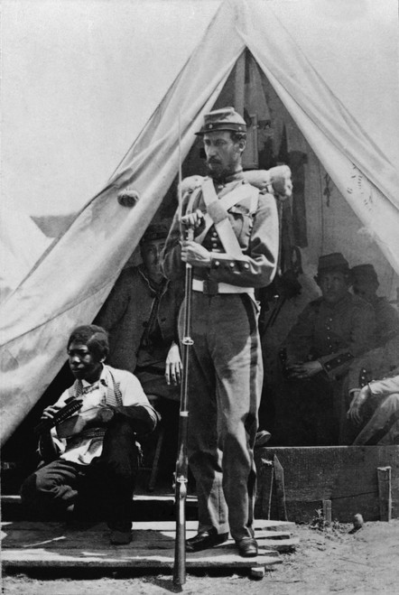 A New York State Soldier Poses Before His Tent At Camp Cameron Holding His Bayoneted Rifle With An African American 'Contraband' Boy Shining Shoes At His Side. Racism And Servile Roles Often Continued For Ex-Slaves In Union Army - Item # VAREVCHISL00