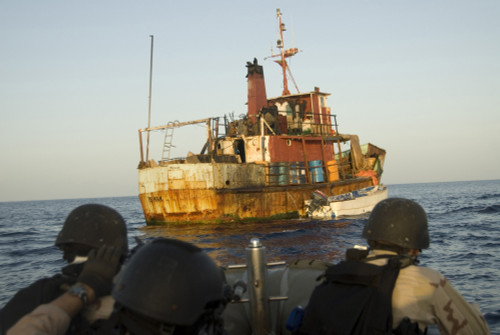 U.S. Navy And Coast Guard Personnel Approach A Suspected Pirate Mothership In The Gulf Of Aden. The Suspects Have Their Hands Raised On An Upper Deck Of The Rusted Ship Which Appears To Have Communications Equipment. May 13 2009 - Item # VAREVCHISL02