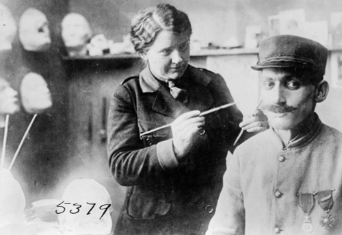 Wwi: Veteran, 1918. /Nmrs. Anna Coleman Ladd, Of The American Red Cross, Putting The Finishing Touches On The Copper Prosthetic Mask Of French Soldier Disfigured In World War I. Photograph, 1918. Poster Print by Granger Collection - Item # VARGRC0326