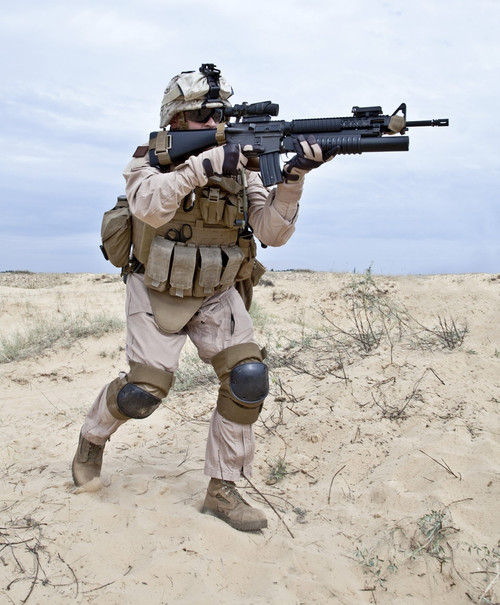 U.S. soldier runs through the desert shooting a gun with grenade launcher. Poster Print by Oleg Zabielin/Stocktrek Image - Item # VARPSTZAB100116M