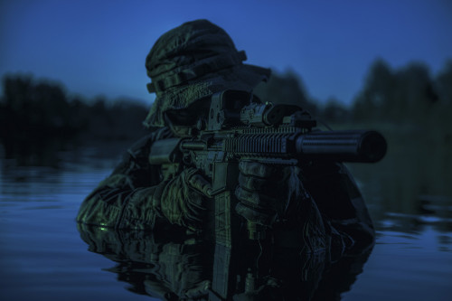 Special forces soldier with rifle in action during a river raid in the jungle under the cover of darkness. Poster Print - Item # VARPSTZAB102774M