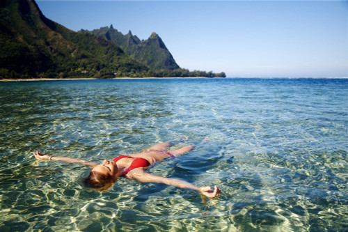 Hawaii, Kauai, Tunnel's Beach, Woman Floats In The Ocean. Poster Print by Kicka Witte / Design Pics - Item # VARDPI1973330