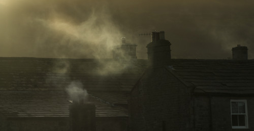 Smoke From Chimneys On A Rooftop Floats Into The Air; Reeth, Yorkshire, England Poster Print by John Short / Design Pics - Item # VARDPI12327816