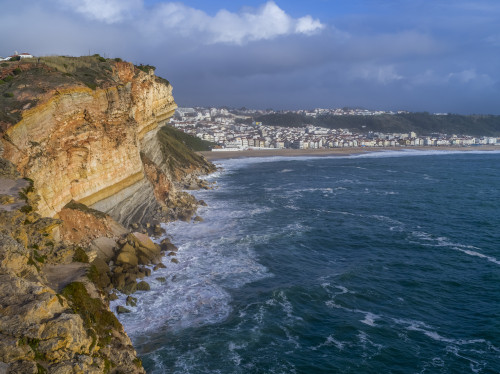 Rugged cliffs and beach along the coastline of Nazare, Portugal, the seaside resort town; Nazare, Portugal Poster Print by Keith Levit / Design Pics - Item # VARDPI12553484