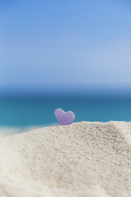 A Lavender Heart Shaped Sea Glass In The Sand At The Beach; Honolulu, Oahu, Hawaii, United States Of America Poster Print by Brandon Tabiolo / Design Pics - Item # VARDPI12326378