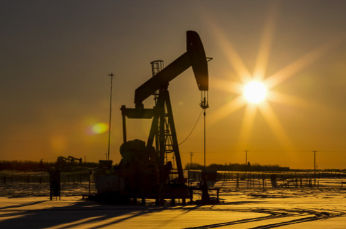 Silhouette of pumpjack in snow-covered area with an orange starburst sun at sunrise; Longview, Alberta, Canada Poster Print by Michael Interisano / Design Pics - Item # VARDPI12554648