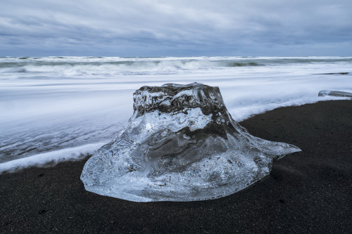 Large chunk of ice sitting on the shore of Iceland with dramatic skies in behind it, near Jokulsarlon ice lagoon; Iceland Poster Print by Robert Postma / Design Pics - Item # VARDPI12550349