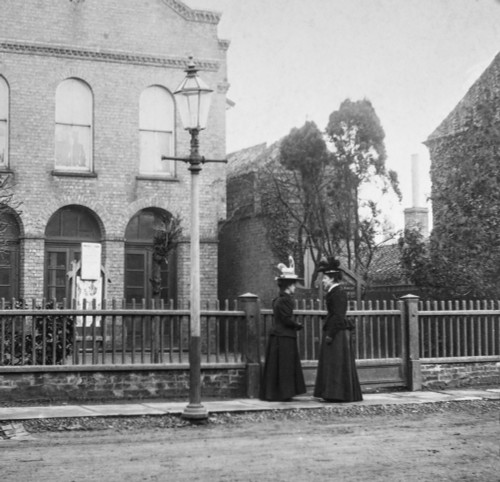 Magic lantern slide circa 1900.Victorian.Social History. Image from a slide presentation entitled In His step or In jesus Name. Two ladies talking outside of church in the street Poster Print by John Short / Design Pics - Item # VARDPI12513228