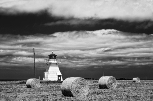 Canada, Prince Edward Island, Darnley. Lighthouse and hay bales. Poster Print by Jaynes Gallery - Item # VARPDDCN09BJY0083