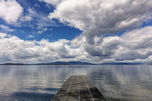 Dock reaches out into Skidoo Bay in Flathead Lake near Polson, Montana, USA Poster Print by Chuck Haney - Item # VARPDDUS27CHA4233