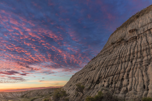 Vivid sunrise clouds over badlands formation in Theodore Roosevelt National Park, North Dakota, USA Poster Print by Chuck Haney - Item # VARPDDUS35CHA0422