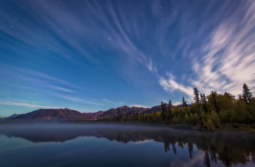Streaks of clouds over Beach Lake at night, Chugach Mountains and autumn coloured woods in the background, South-central Alaska in autumn; Chugiak, Alaska, United States of America Poster Print by Sunny Awazuhara- Reed (19 x 12) # 33293852