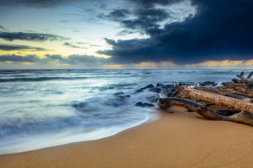 Sunrise over beach and ocean with a storm cloud and rain in the distance; Kauai, Hawaii, United States of America Poster Print by The Nature Collection (19 x 12) # 12575019