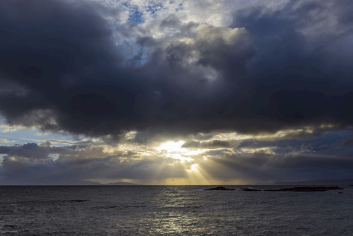 Sun shining through the storm clouds at sunrise along the Scottish coast at Mallaig in Scotland, United Kingdom Poster Print by Raimund Linke (19 x 12)