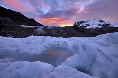 Frozen pool of water on the ice of the Gorner Glacier at sunrise.; Gornergrat, Zermatt, Switzerland. Poster Print by Robbie Shone (20 x 13)