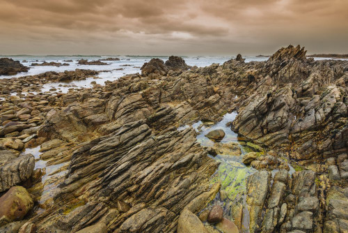 Jagged rock formations on the rocky shore at Cape Agulhas in Agulhas National Park; Western Cape, South Africa Poster Print by Alberto Biscaro (20 x 13)
