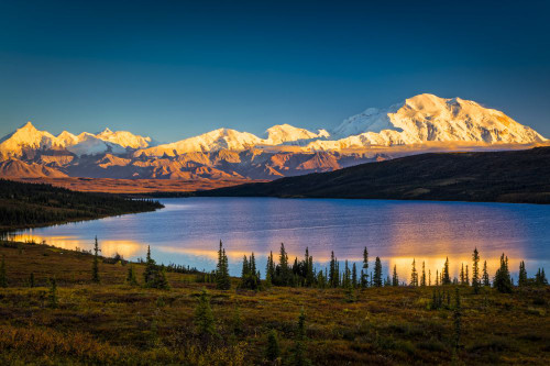 Sunset glow on Mount Denali (McKinley) reflects on Wonder Lake with blue sky, Denali National Park and Preserve in autumn, Interior Alaska; Alaska, United States of America Poster Print by Sunny Awazuhara- Reed (20 x 13)