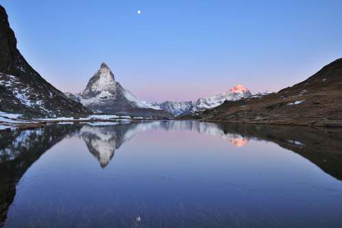 Matterhorn reflected in Lake Riffelsee at Dawn with Moon, Zermatt, Alps, Valais, Switzerland Poster Print by Raimund Linke (17 x 11)