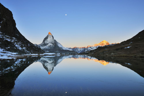 Matterhorn reflected in Lake Riffelsee at Sunrise with Moon, Zermatt, Alps, Valais, Switzerland Poster Print by Raimund Linke (19 x 12)