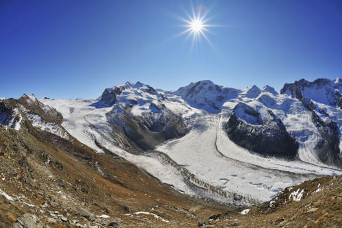 View from Gonergrat with Sun over Gorner Glacier, Monte Rosa Glacier and Monte Rosa Mountain Range, Zermatt, Alps, Valais, Switzerland Poster Print by Raimund Linke (19 x 12)
