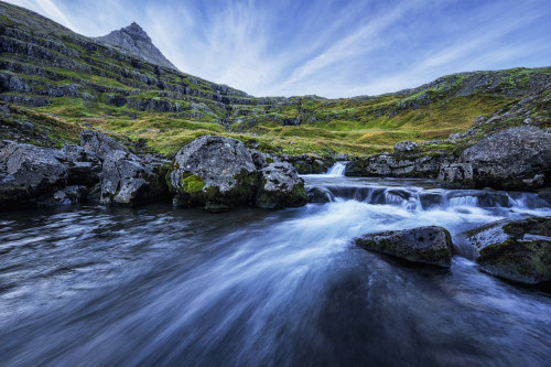 A Mountain Stream Runs Toward The Ocean In The Fjord Called Mjoifjordur, East Iceland; Iceland Poster Print by Robert Postma (18 x 12)