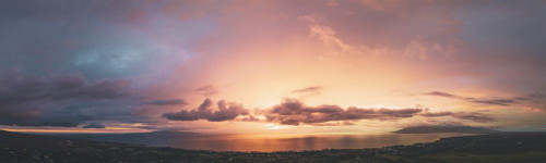 Panoramic view of the glowing pink sky at sunset over the Pacific Ocean from the town of Kihei, Maui, Hawaii, USA; Kihei, Maui, Hawaii, United States of America Poster Print by Living Moments Media (36 x 10)