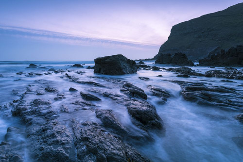 Rocks exposed by the retreating tide at Duckpool on the Hartland heritage coast of south west England. Poster Print by Loop Images Ltd. (20 x 13)