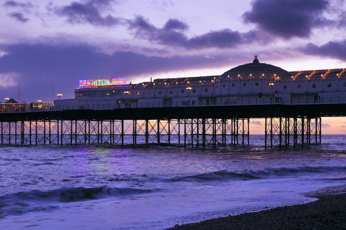 Brighton Palace Pier seen at sunset as dusk begins to fall. Poster Print by Loop Images Ltd. (17 x 11)