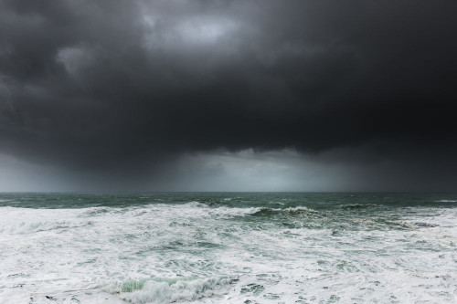 Dark violent dramatic storm clouds over Fistral Bay in Newquay in Cornwall. Poster Print by Loop Images Ltd. (20 x 13)