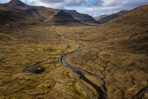 A scenic long road in a valley in Saksun on the Faroe Islands. Poster Print by Loop Images Ltd. (18 x 12)