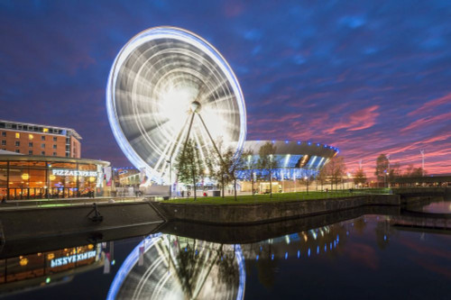 Liverpool ferris wheel and arena reflected at night with apocalyptic sky in Liverpool. Poster Print by Loop Images Ltd. (18 x 12)