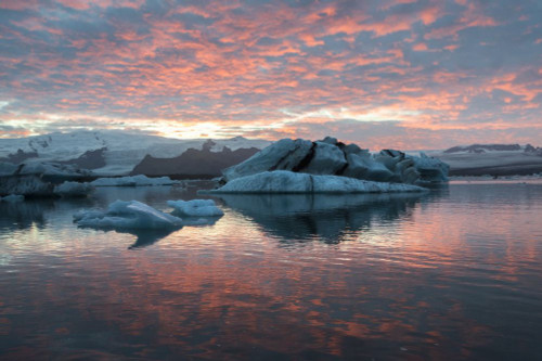 A dramatic red sunset at Jokulsarlon Iceberg Lagoon. Poster Print by Loop Images Ltd. (17 x 11)