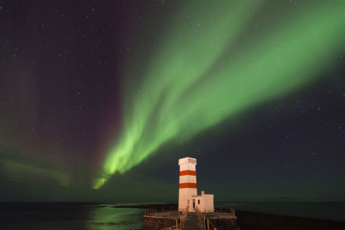 The Aurora Borealis above Gardur lighthouse. Poster Print by Loop Images Ltd. (17 x 11)