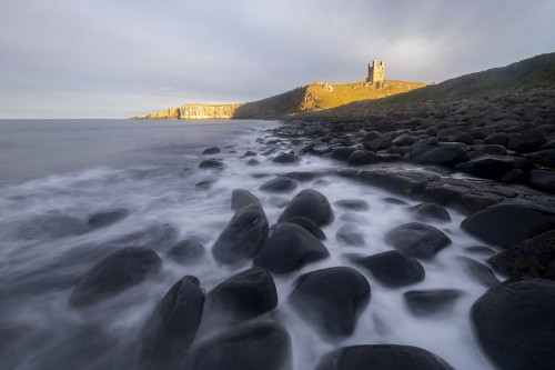 Dunstanburgh Castle in Northumberland. Poster Print by Loop Images Ltd. (20 x 13)