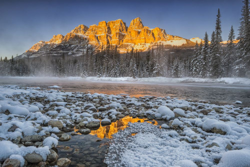 Castle Mountain in winter reflected in the Bow River. Poster Print by Loop Images Ltd. (18 x 12)