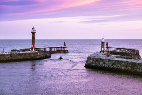 A fishing boat leaves Whitby harbour on the morning tide. Poster Print by Loop Images Ltd. (19 x 13)