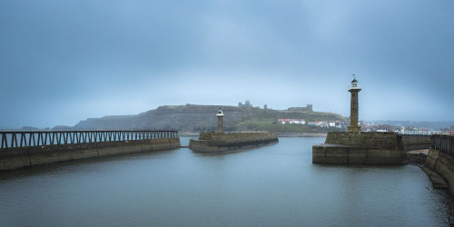 Entrance to the harbour at  Whitby looking back towards the town. Poster Print by Loop Images Ltd. (20 x 10)