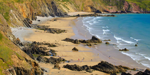 People on the sandy beach at Marloes rated as one of the best beaches in Britain. Poster Print by Loop Images Ltd. (20 x 10)