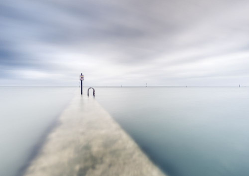 On the wall of the Margate tidal pool at high tide in Kent. Poster Print by Loop Images Ltd. (18 x 13)
