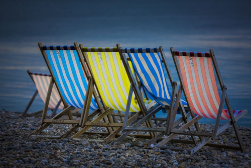 Empty deck chairs on a beach. Poster Print by Loop Images Ltd. (18 x 12)